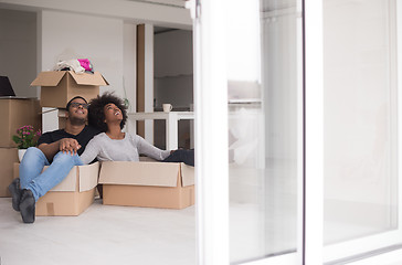 Image showing African American couple  playing with packing material