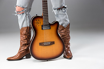 Image showing Legs in Jeans and Cowboys Boots