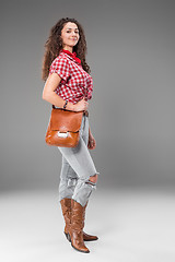 Image showing The cowgirl fashion woman over a gray background