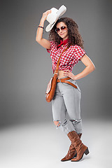 Image showing The cowgirl fashion woman over a gray background