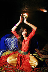Image showing young pretty asian girl in bright colored interior on carpet view, oriental concept
