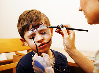 Image showing little cute child making facepaint on birthday party, zombie Apo