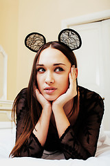 Image showing young pretty brunette woman wearing sexy lace mouse ears, laying