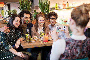 Image showing friends with smartphone photographing at cafe