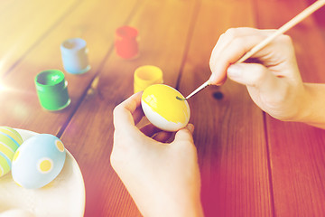 Image showing close up of woman hands coloring easter eggs