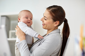 Image showing happy businesswoman with baby at office