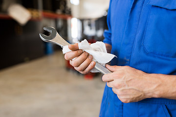 Image showing auto mechanic or smith with wrench at car workshop