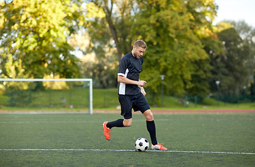 Image showing soccer player playing with ball on football field