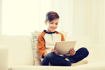 Image showing smiling boy with tablet computer at home