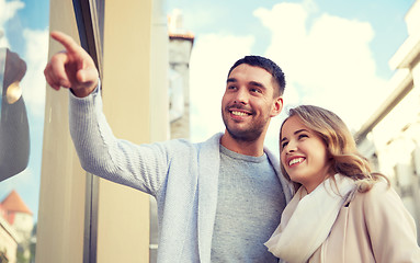 Image showing happy couple shopping and looking at shop window