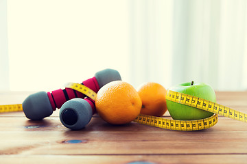 Image showing close up of dumbbell, fruits and measuring tape