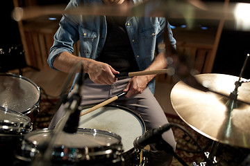 Image showing male musician playing drums and cymbals at studio