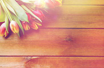 Image showing close up of tulip flowers on wooden table