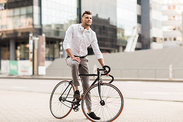 Image showing man with bicycle and headphones on city street