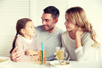 Image showing happy family having dinner at restaurant or cafe