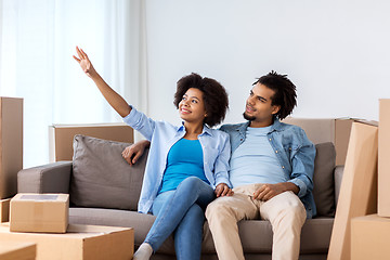 Image showing happy couple with boxes moving to new home