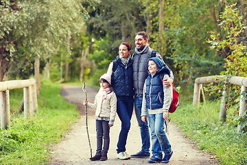 Image showing happy family with backpacks hiking