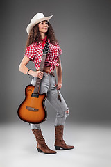 Image showing The cowgirl fashion woman over a gray background