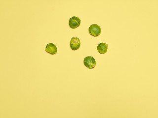 Image showing The piles of Brussels sprouts on a yellow background