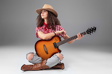 Image showing The cowgirl fashion woman over a gray background