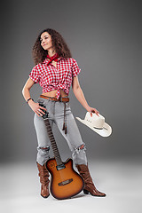 Image showing The cowgirl fashion woman over a gray background