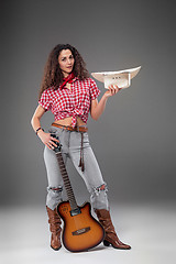 Image showing The cowgirl fashion woman over a gray background