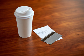 Image showing coffee in paper cup, bill and credit card on table