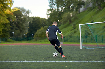 Image showing soccer player playing with ball on football field