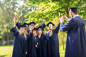 Image showing students or bachelors photographing by smartphone