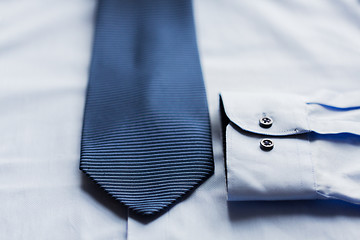 Image showing close up of shirt and blue patterned tie