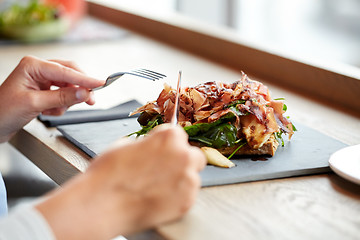 Image showing woman eating prosciutto ham salad at restaurant