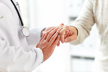 Image showing close up of doctor holding old man hand