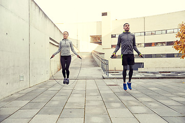 Image showing man and woman exercising with jump-rope outdoors