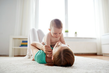 Image showing happy mother playing with baby at home