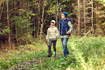 Image showing two happy kids walking along forest path