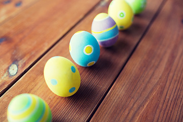 Image showing close up of colored easter eggs on wooden surface