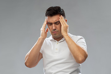 Image showing unhappy man suffering from head ache