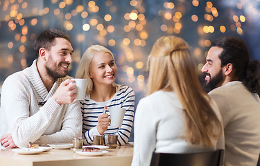 Image showing happy friends meeting and drinking tea