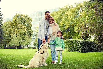 Image showing happy family with labrador retriever dog in park