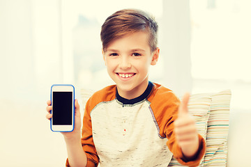 Image showing smiling boy with smartphone at home