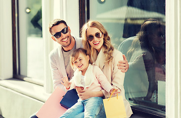 Image showing happy family with child and shopping bags in city