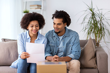 Image showing happy couple with parcel box and paper form home