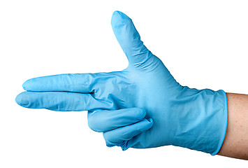 Image showing Hand in blue latex glove fingers pistol
