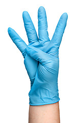 Image showing Hand in blue latex glove showing four fingers