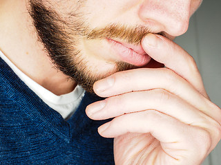 Image showing Male person, at closeup with fingers in beard