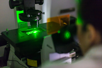 Image showing Life science researcher microscoping in genetic scientific laboratory.