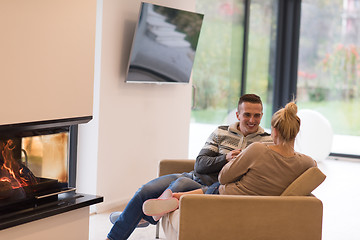 Image showing Young couple  in front of fireplace