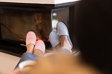 Image showing Young multiethnic couple  in front of fireplace