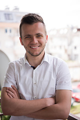 Image showing man standing at balcony