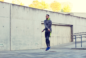 Image showing man exercising with jump-rope outdoors